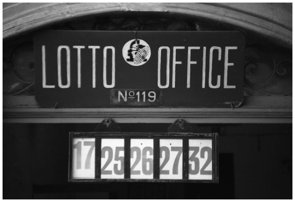 A vintage Maltese Lotto Office sign and numbered draw display