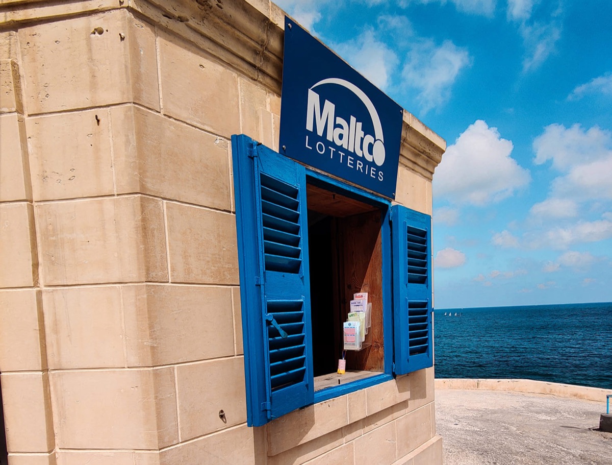 A National Lottery booth in Malta, its shutters open to the sea front